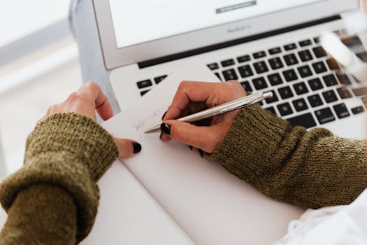 woman writing on a notepad