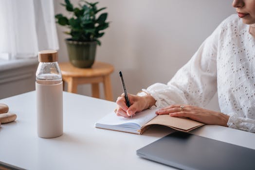 creative workspace with a journal and plants