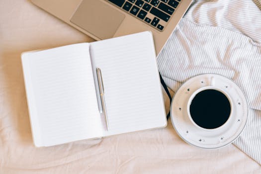 A cozy workspace with a journal and a cup of coffee