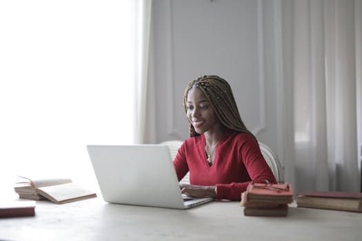 woman smiling while typing at her desk