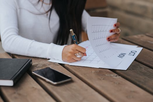 Image of a woman writing headlines on a notepad